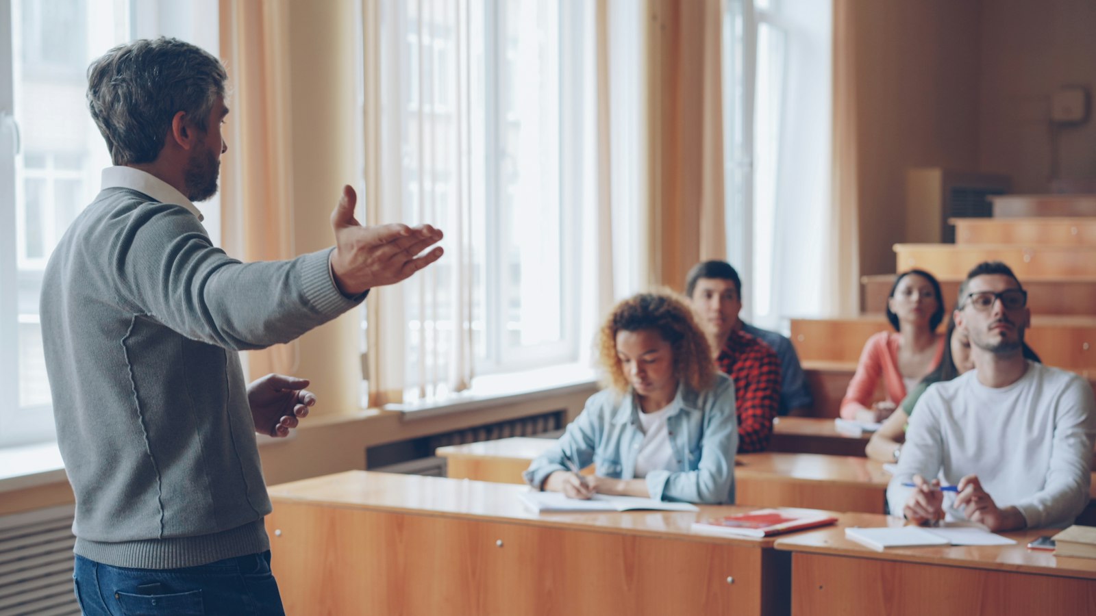 Lecturer leading a discussion with students in a classroom