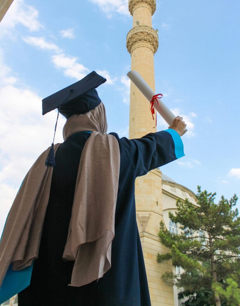 canva a person in black academic dress holding a diploma magzlnpwwaa